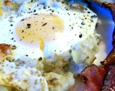 Baked Eggs On A Bed Of Potatoes With Bacon