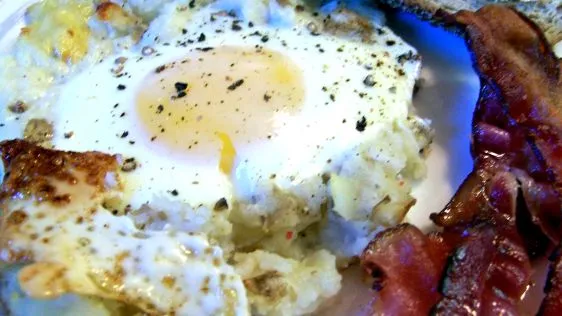 Baked Eggs On A Bed Of Potatoes With Bacon