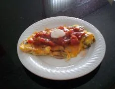 Certainly not your everyday boring eggs This recipe is based on a dish at International House of Pancakes called chicken fajita omelet I have omitted the chicken