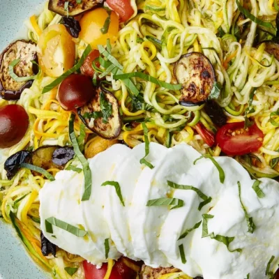 Raw Spiralized Zucchini Noodles With Tomatoes And Pesto