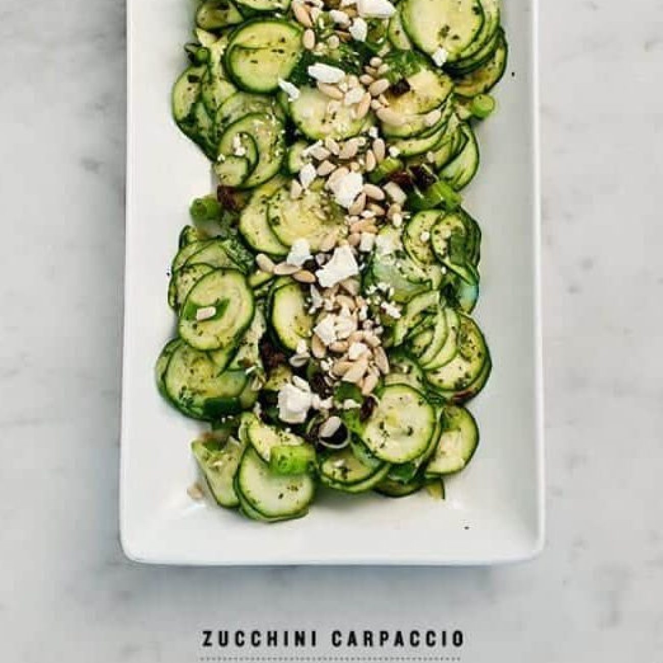 Fresh Zucchini Carpaccio Topped with Feta Cheese and Pine Nuts